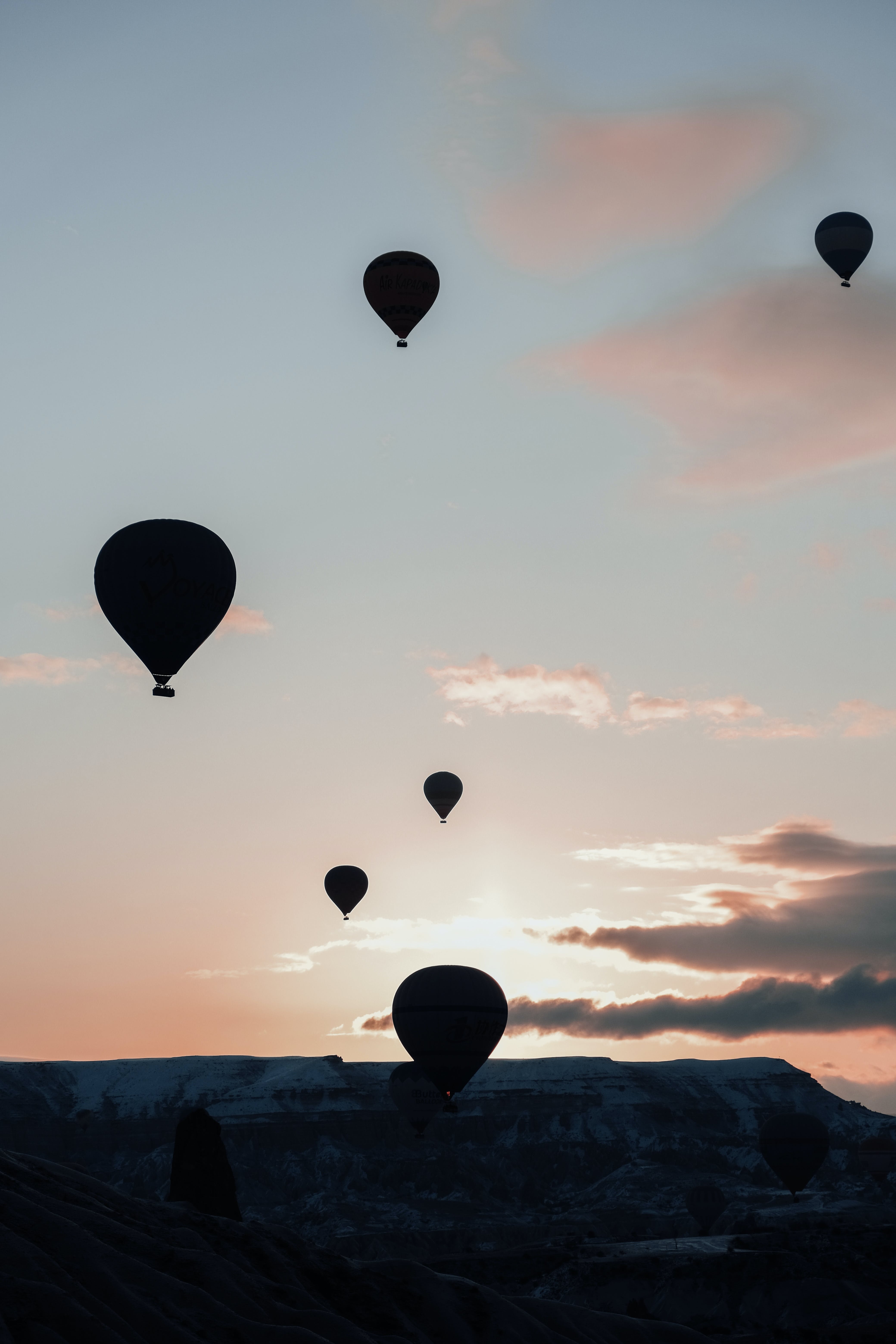 hot air balloons in the sky during sunset