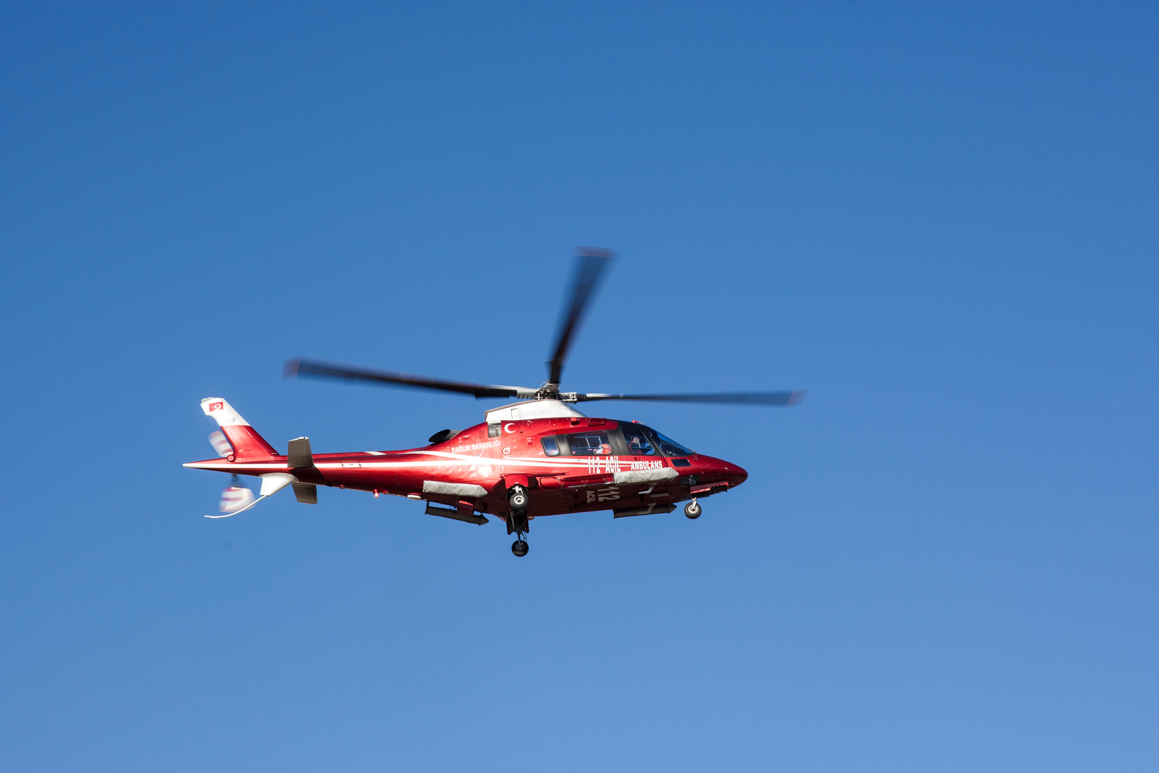 flying red and white helicopter