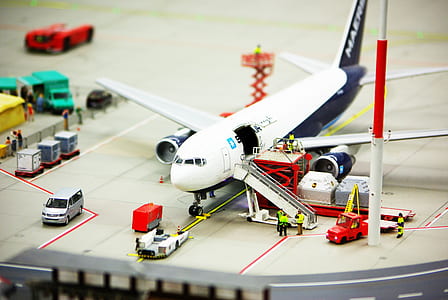 Royalty-Free photo: White airliner at the port with luggages - PickPik