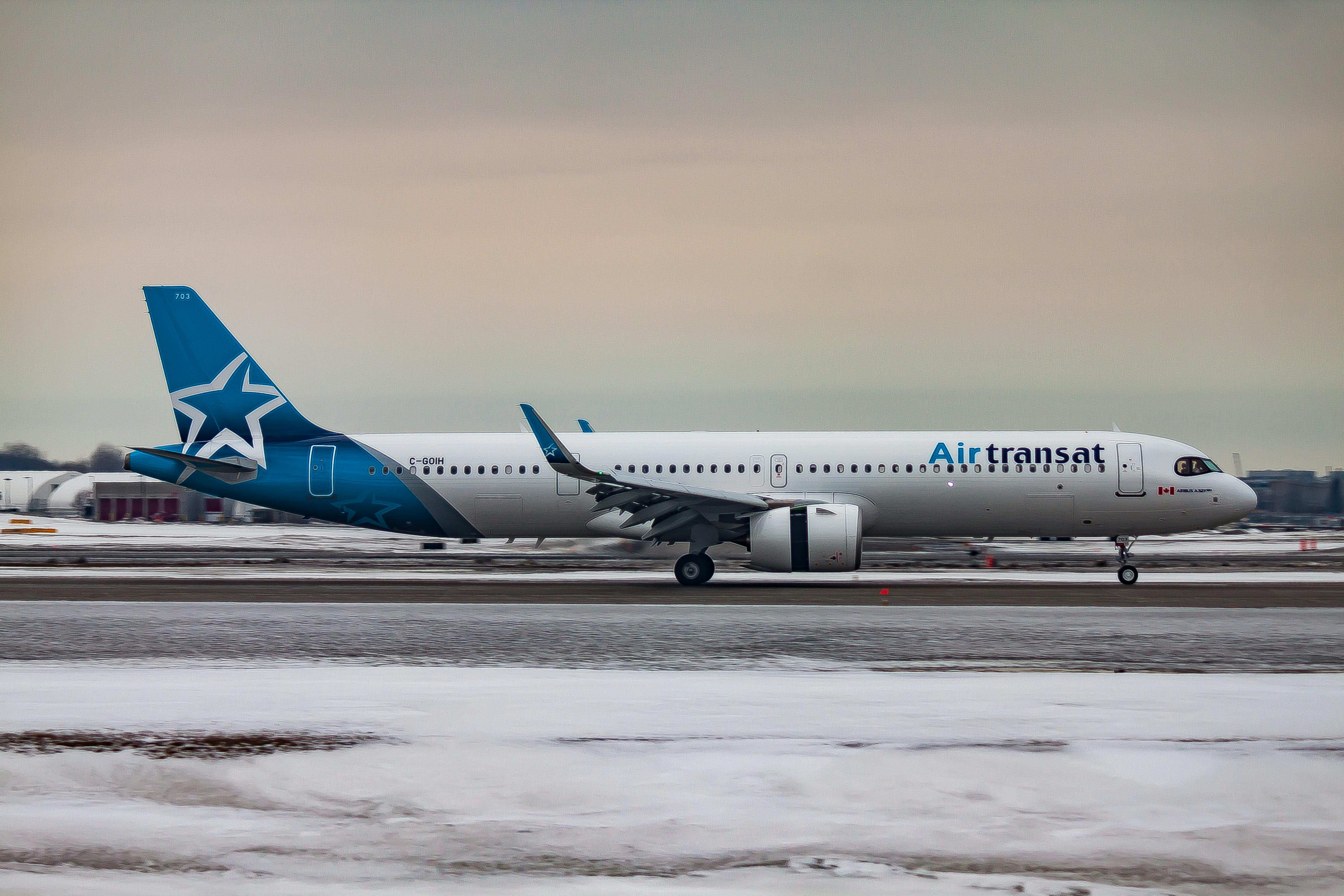 airplane driving on airport runway during sundown