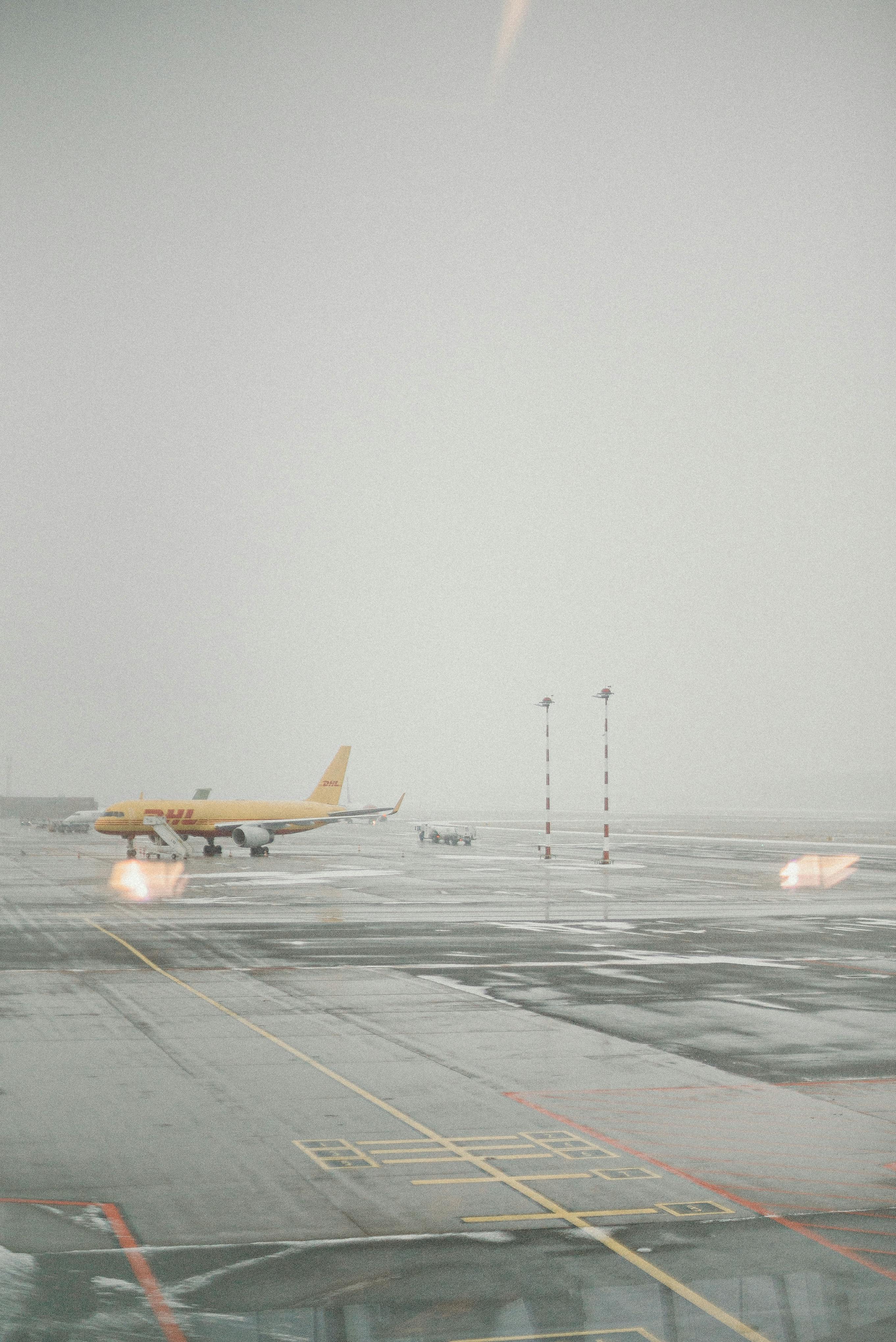 yellow and white plane on airport