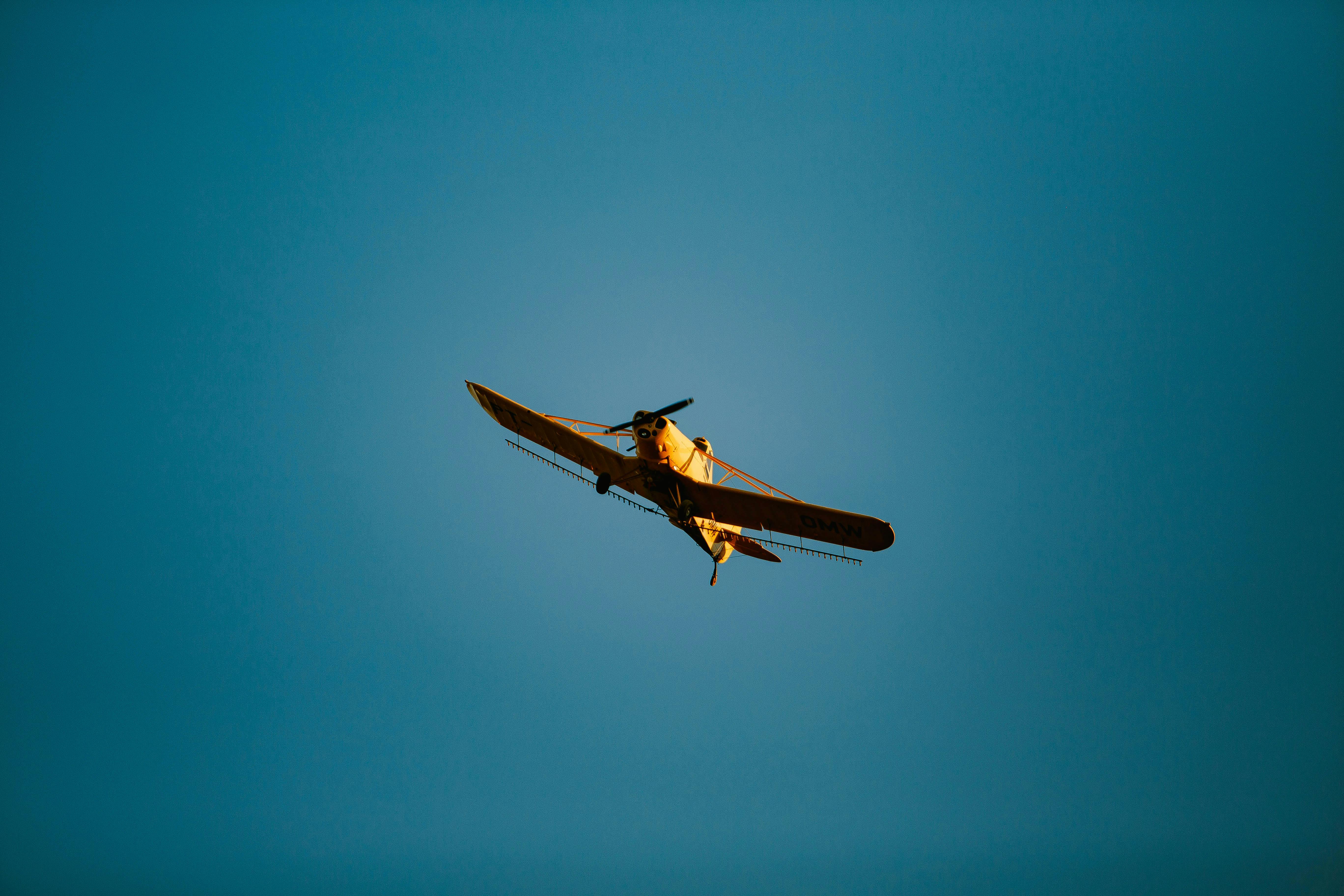 small airplane flying in blue sky