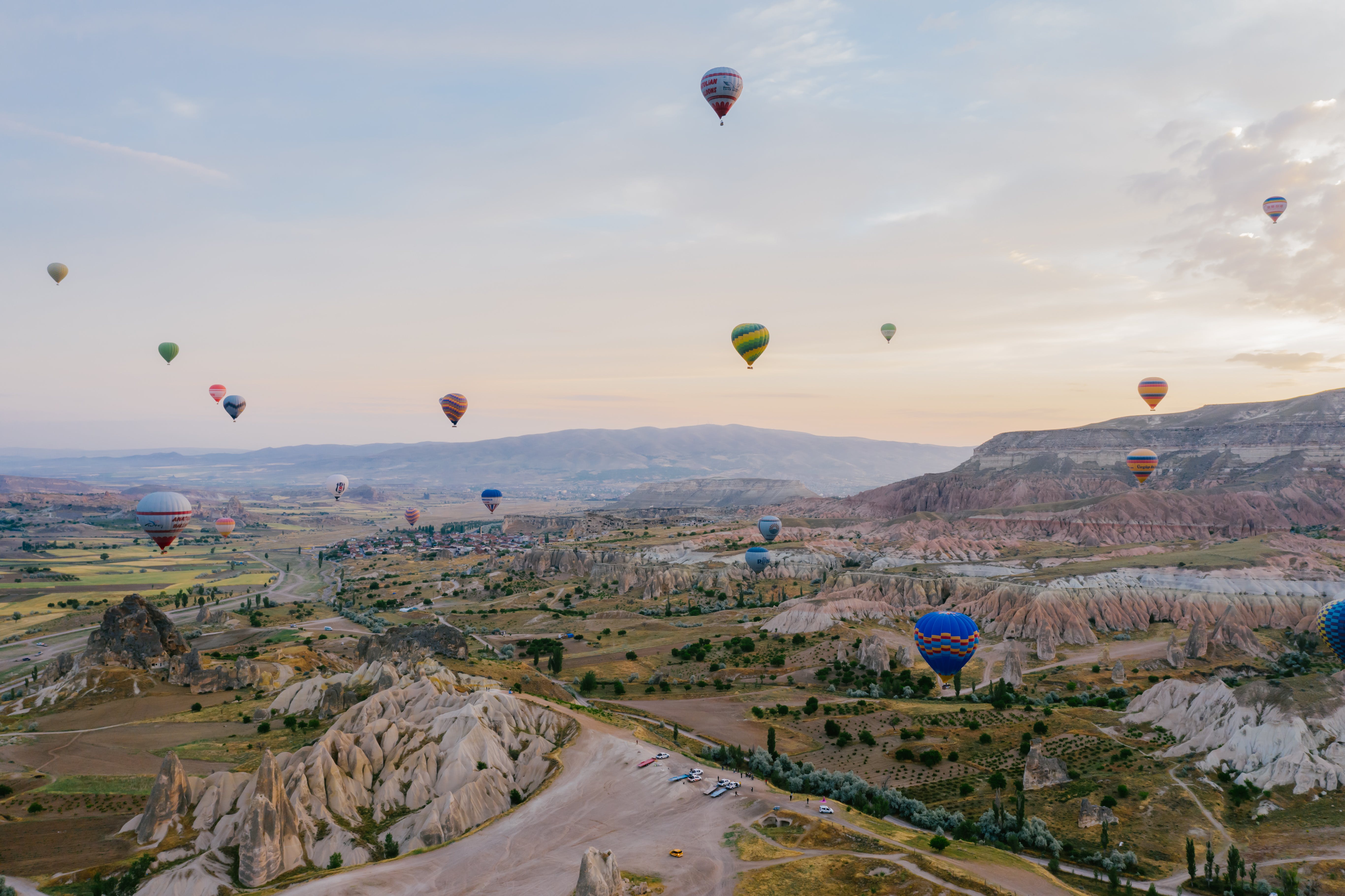 hot air balloons flying under white sky